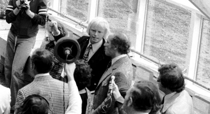 Pierre Trudeau and visitors touring inside the PEI Ark at the September 1976 opening: a crowd with press cameras and microphones, greenhouse glazing visible behind the group.