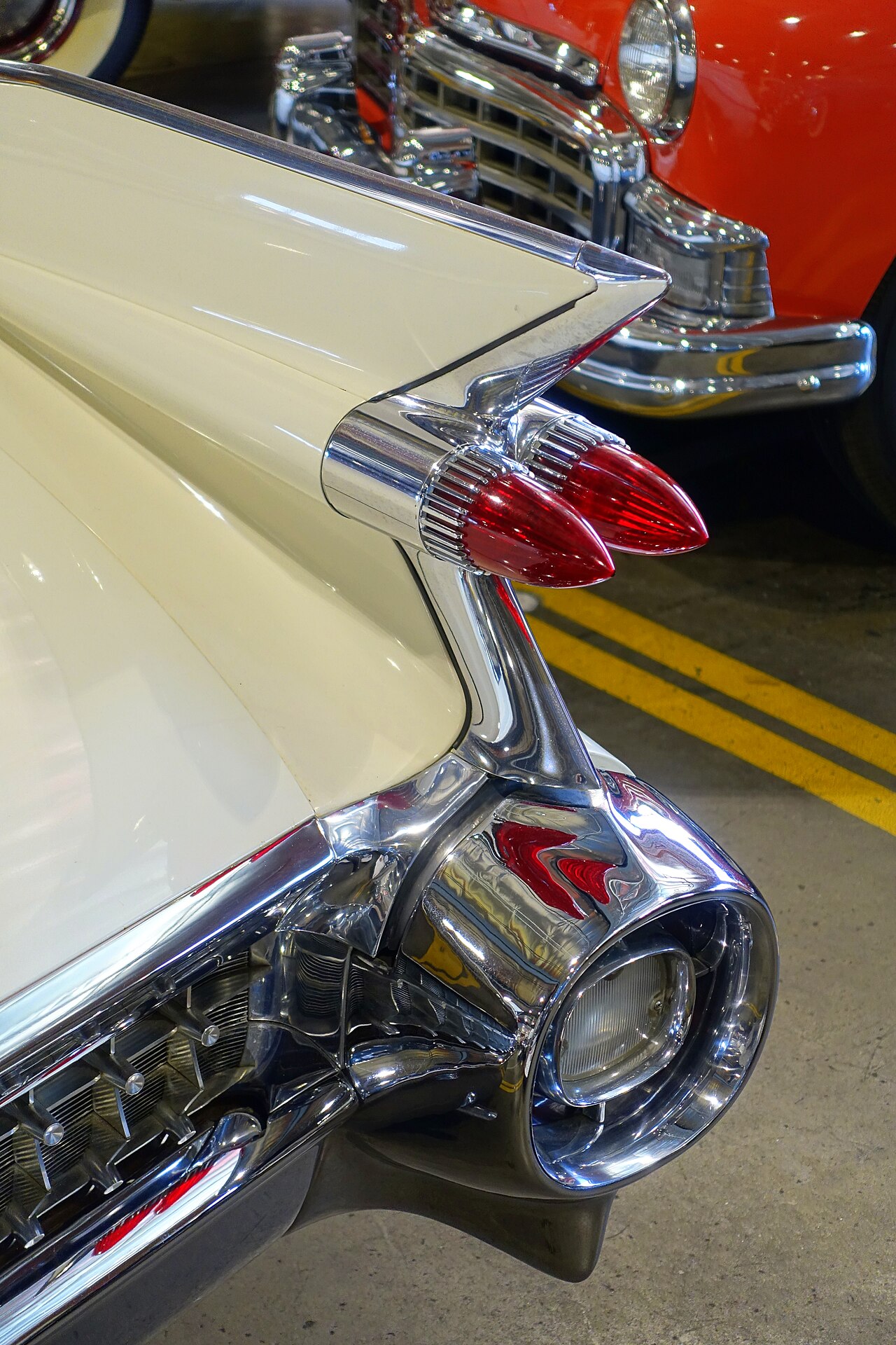 The rear of a 1959 Cadillac, a tall chrome-edged fin with a bullet tail light.