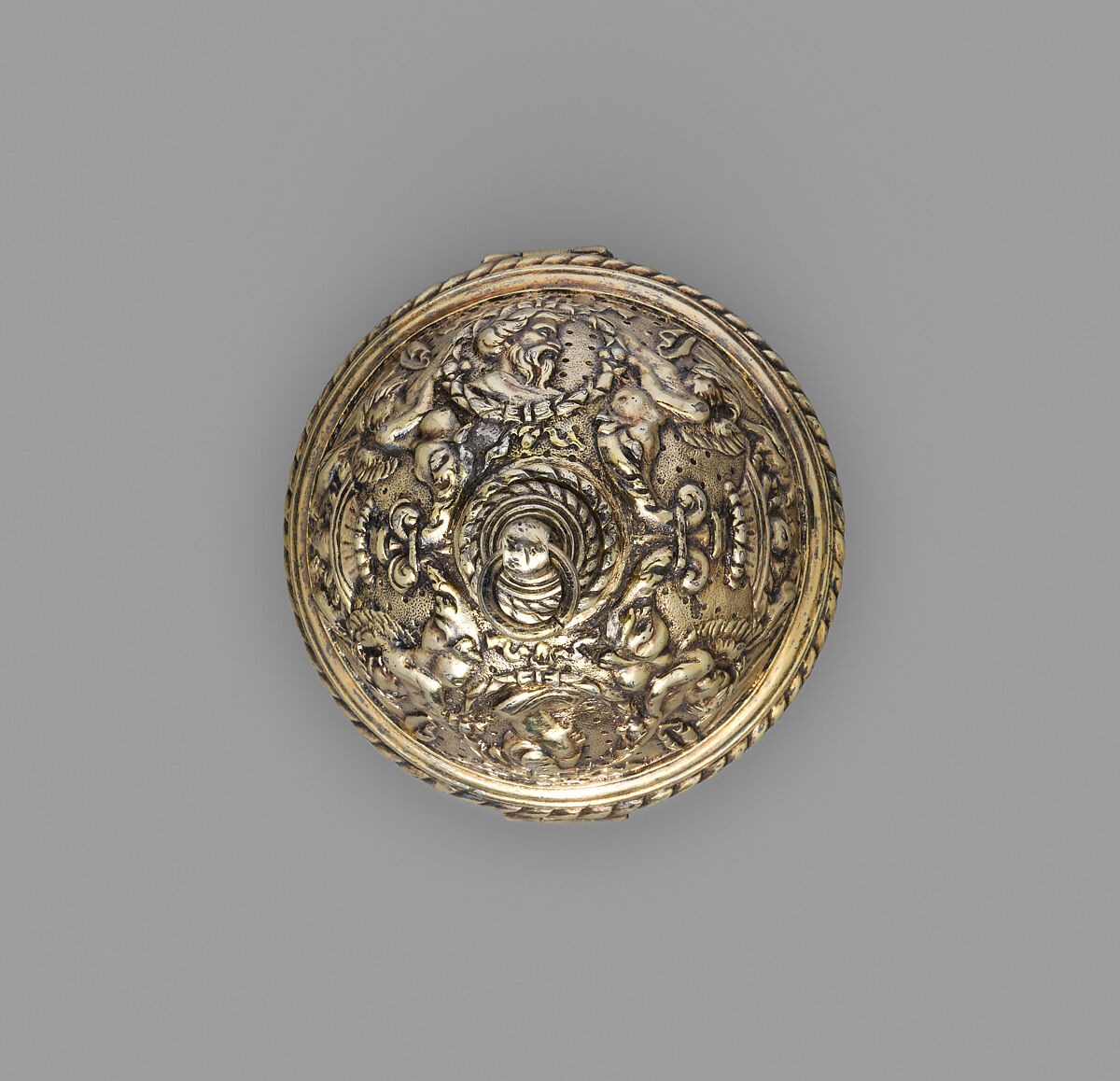 The closed bead seen from above: gilded silver worked with foliage and figures, punctured by small pierced holes.