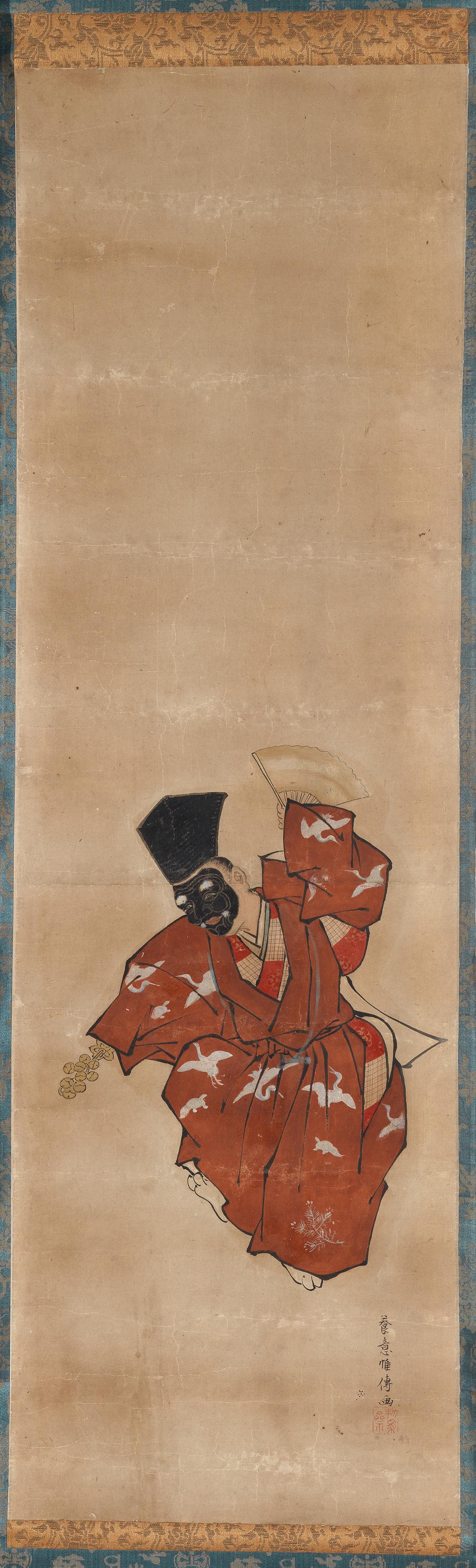 A vertical hanging scroll, dimmed and partly withheld: a masked dancer in a red robe scattered with white cranes, one sleeve lifted, a gold bell-tree held low.